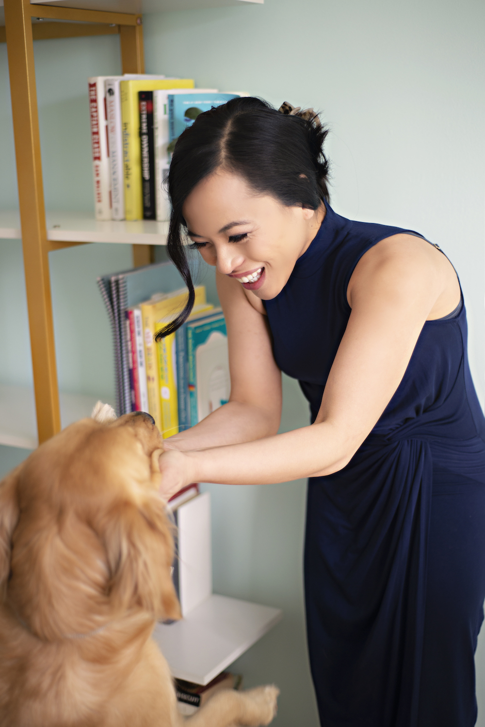 Photo of Nancy Dabu and her golden retriever Luna, taken in her office.